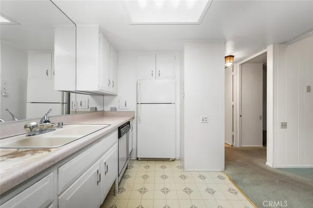 a kitchen with a sink and a refrigerator