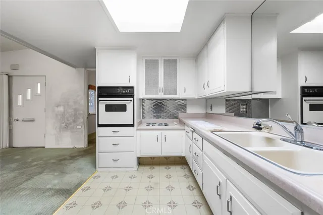 a kitchen with granite countertop a sink and cabinets