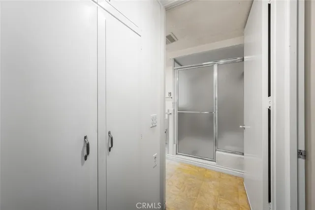 a bathroom with a glass shower door