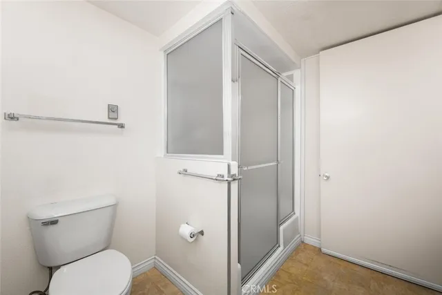 a bathroom with a toilet and a shower