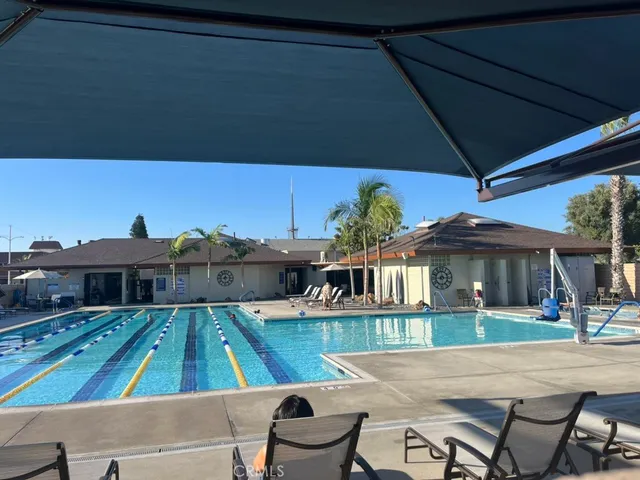 a view of a patio with table and chairs under an umbrella
