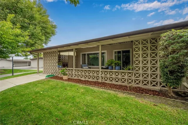 a view of house with backyard porch and garden