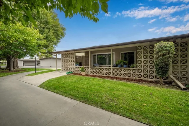 a view of a house with a yard and a garden