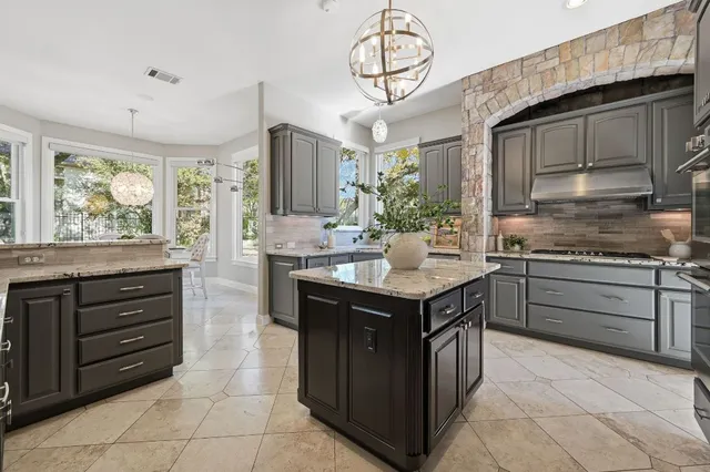 a kitchen with a sink stove and cabinets