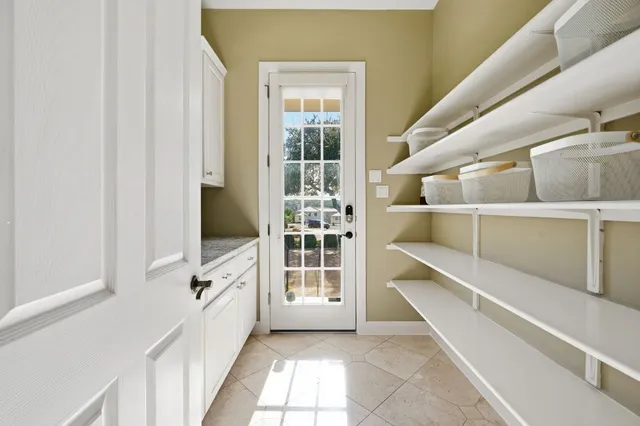 a view of a hallway with white walls and windows
