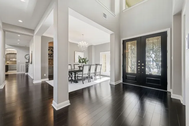 a view of a livingroom with furniture wooden floor and a large window