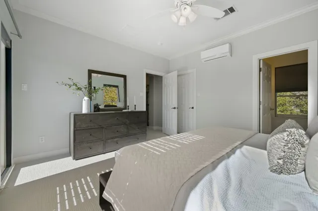 a bedroom with a large bed and a chandelier