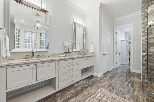 a spacious bathroom with double sink and a mirror