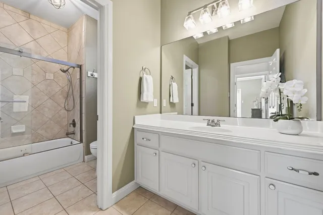 a bathroom with a double vanity sink mirror and shower
