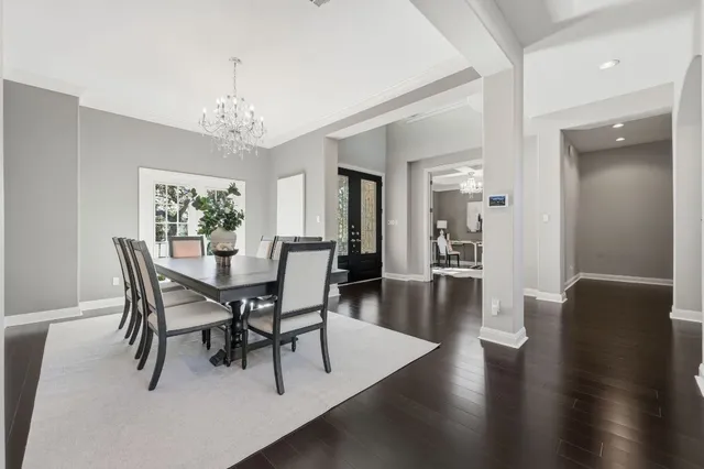 a view of a dining room with furniture wooden floor and chandelier