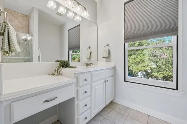 a bathroom with a sink a mirror and a window