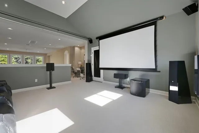 a view of a big room with windows and chairs