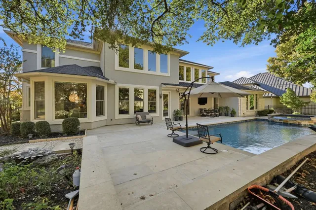 a view of a patio with table and chairs under an umbrella
