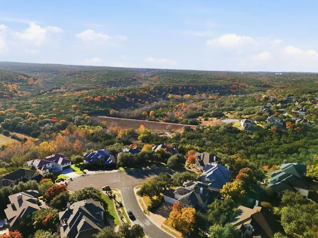 an aerial view of residential building and lake