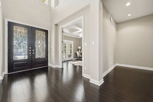 a view of interior space with wooden floor and windows
