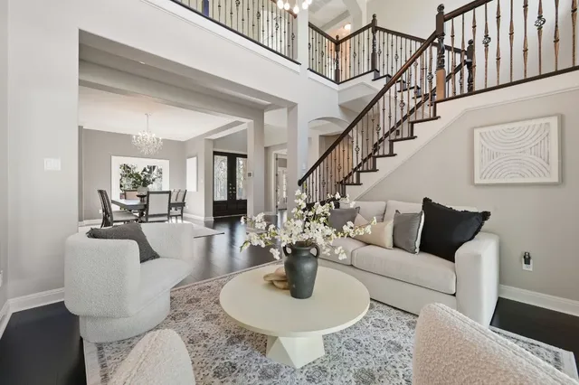 a living room with furniture or couch and a chandelier