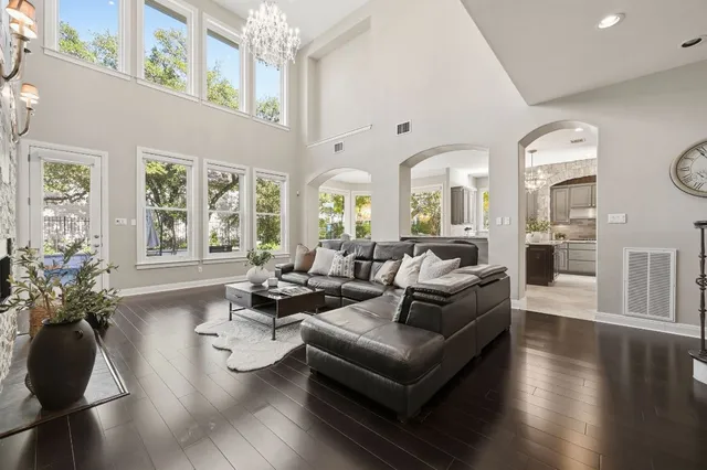 a living room with fireplace furniture and a large window