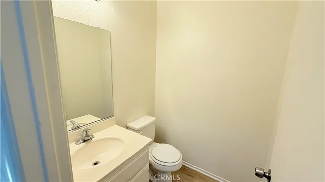 a view of hallway with stainless steel appliances granite countertop cabinets and a refrigerator