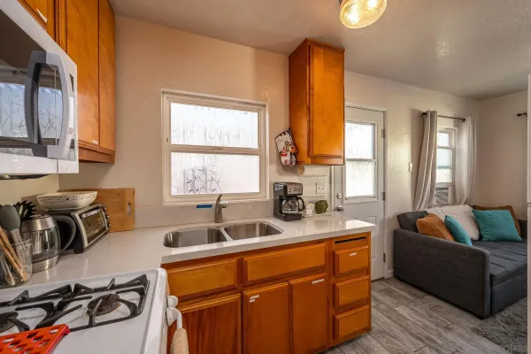 a kitchen with sink a window and couch