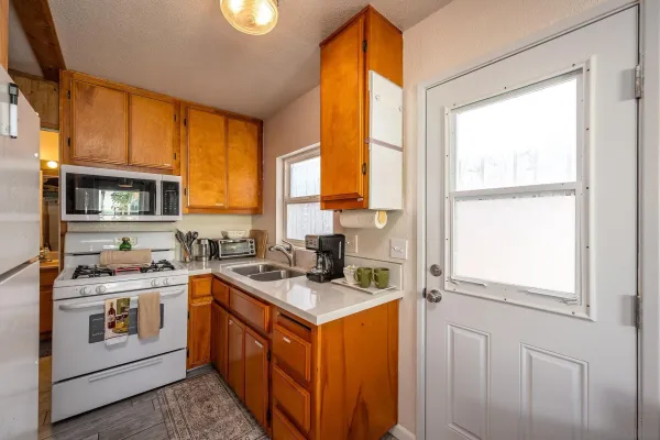 a kitchen with stainless steel appliances granite countertop a refrigerator and a stove top oven
