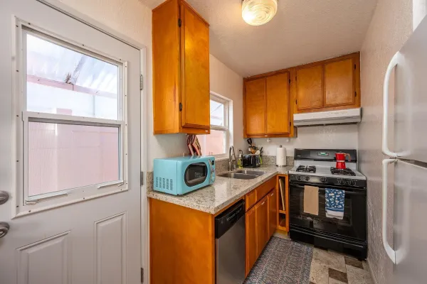 a kitchen with stainless steel appliances granite countertop a stove a refrigerator and a sink