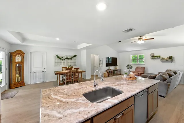 a view of kitchen island a sink and living room