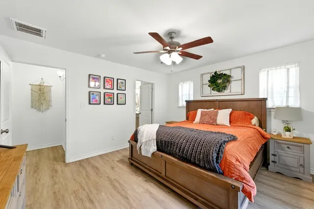 a bedroom with a bed and wooden floor