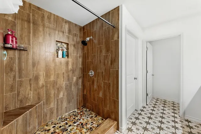 a bathroom with a shower and a sink