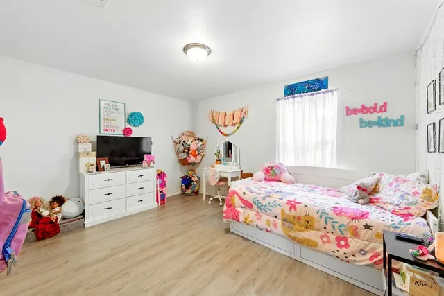 a bedroom with a bed and a tv