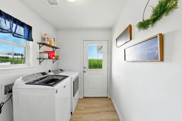 a kitchen that has a sink and a stove with wooden floor