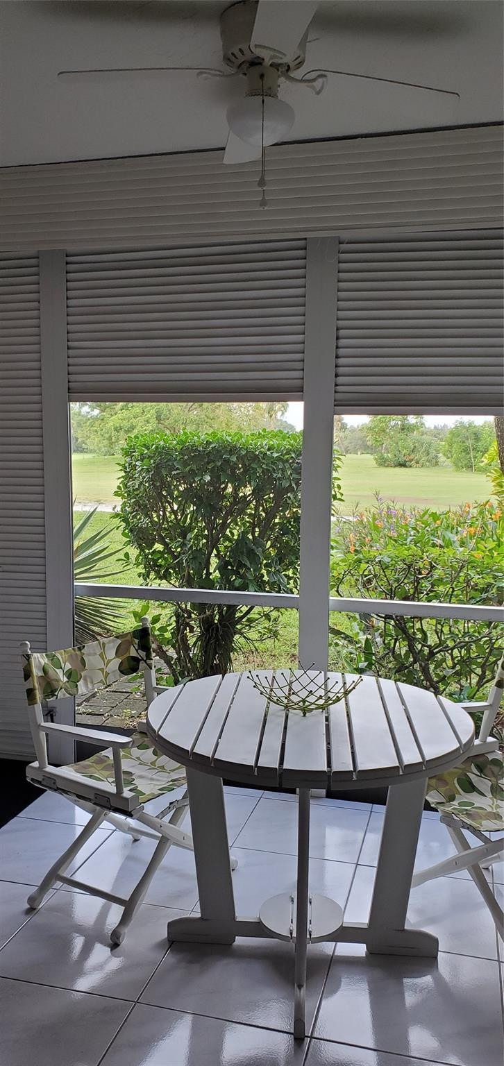 2671 South Course Drive, Unit 108 Pompano Beach, FL 33069 - Photo 18 of 40 a living room with patio furniture and a potted plants