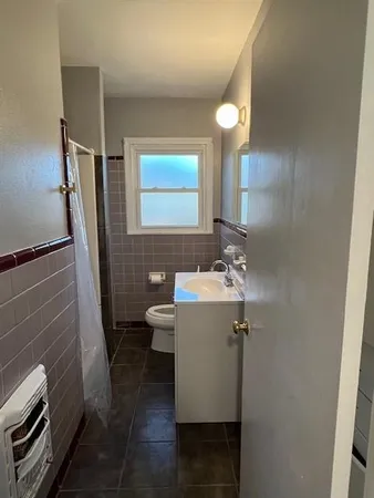 a bathroom with a sink a toilet and mirror