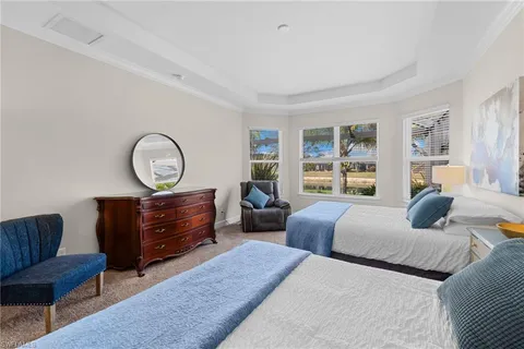 a bedroom with two beds and a large window