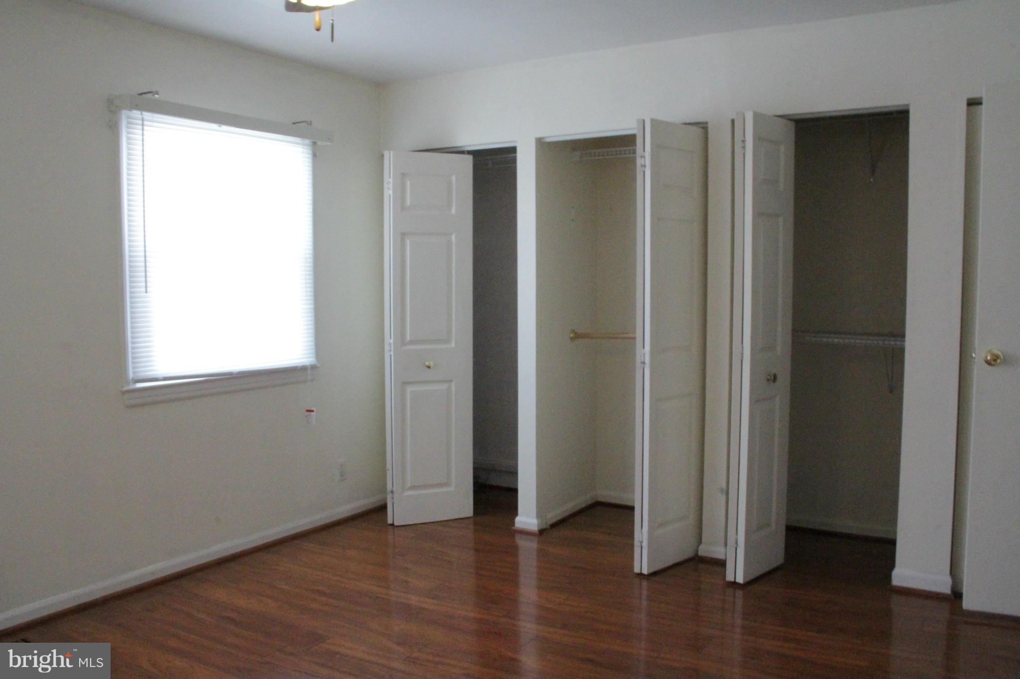 204 West Ash Road Sterling, VA 20164 - Photo 11 of 14 an empty room with wooden floor and windows
