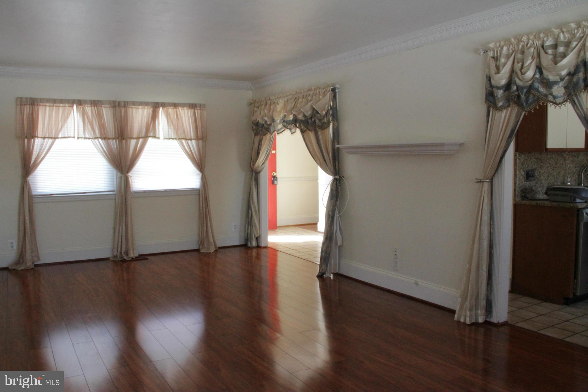 204 West Ash Road Sterling, VA 20164 - Photo 7 of 14 an empty room with wooden floor and windows