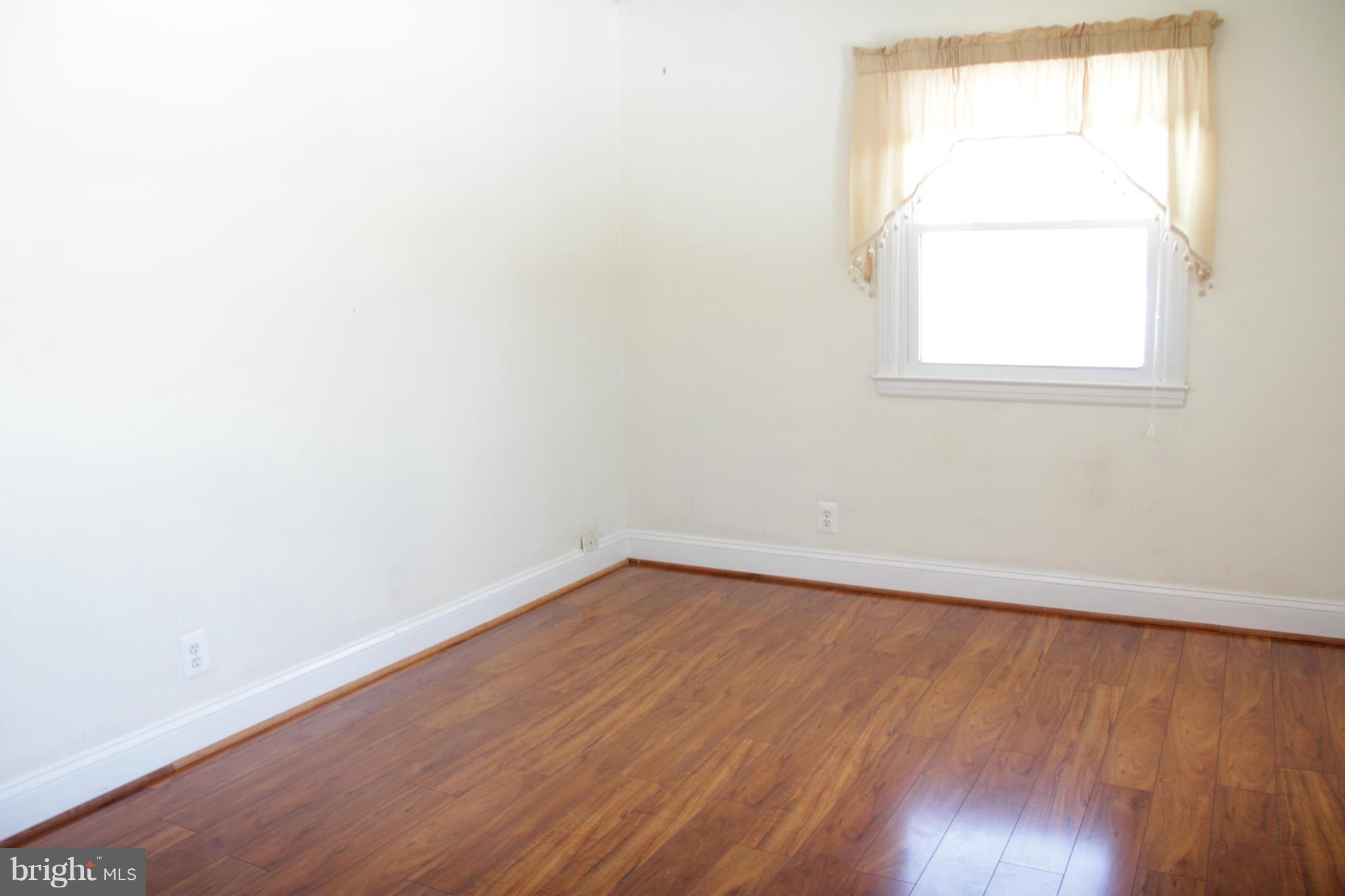 204 West Ash Road Sterling, VA 20164 - Photo 9 of 14 an empty room with wooden floor and windows