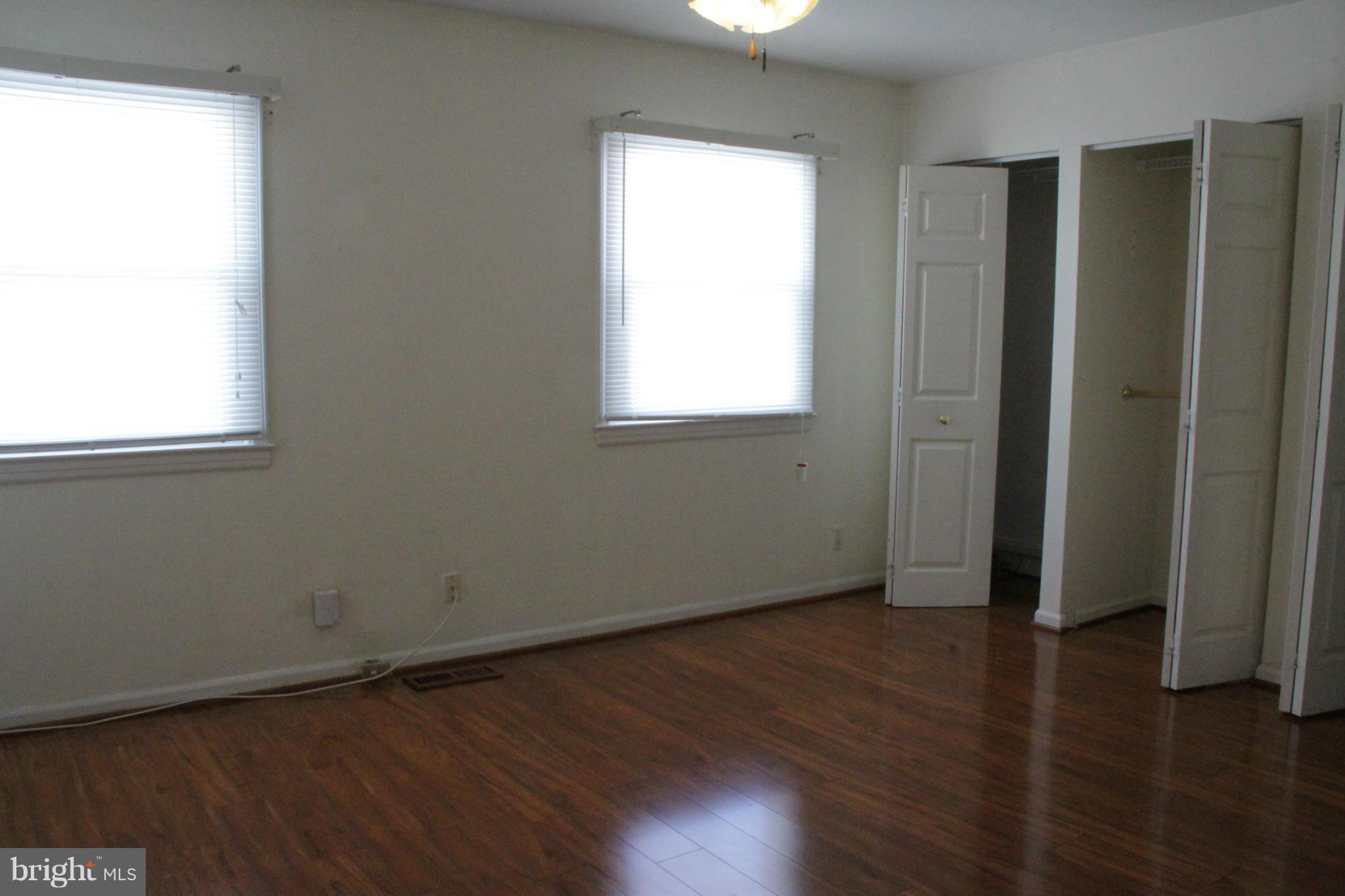 204 West Ash Road Sterling, VA 20164 - Photo 10 of 14 an empty room with wooden floor and windows