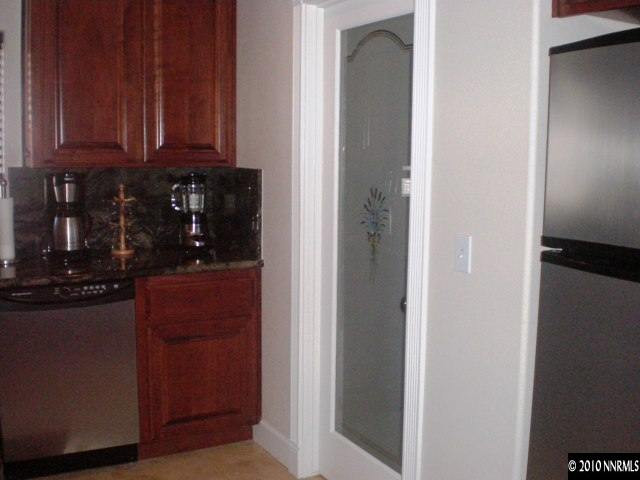 1622 Ray Court Fernley, NV 89408 - Photo 7 of 9 a kitchen with a refrigerator and cabinets