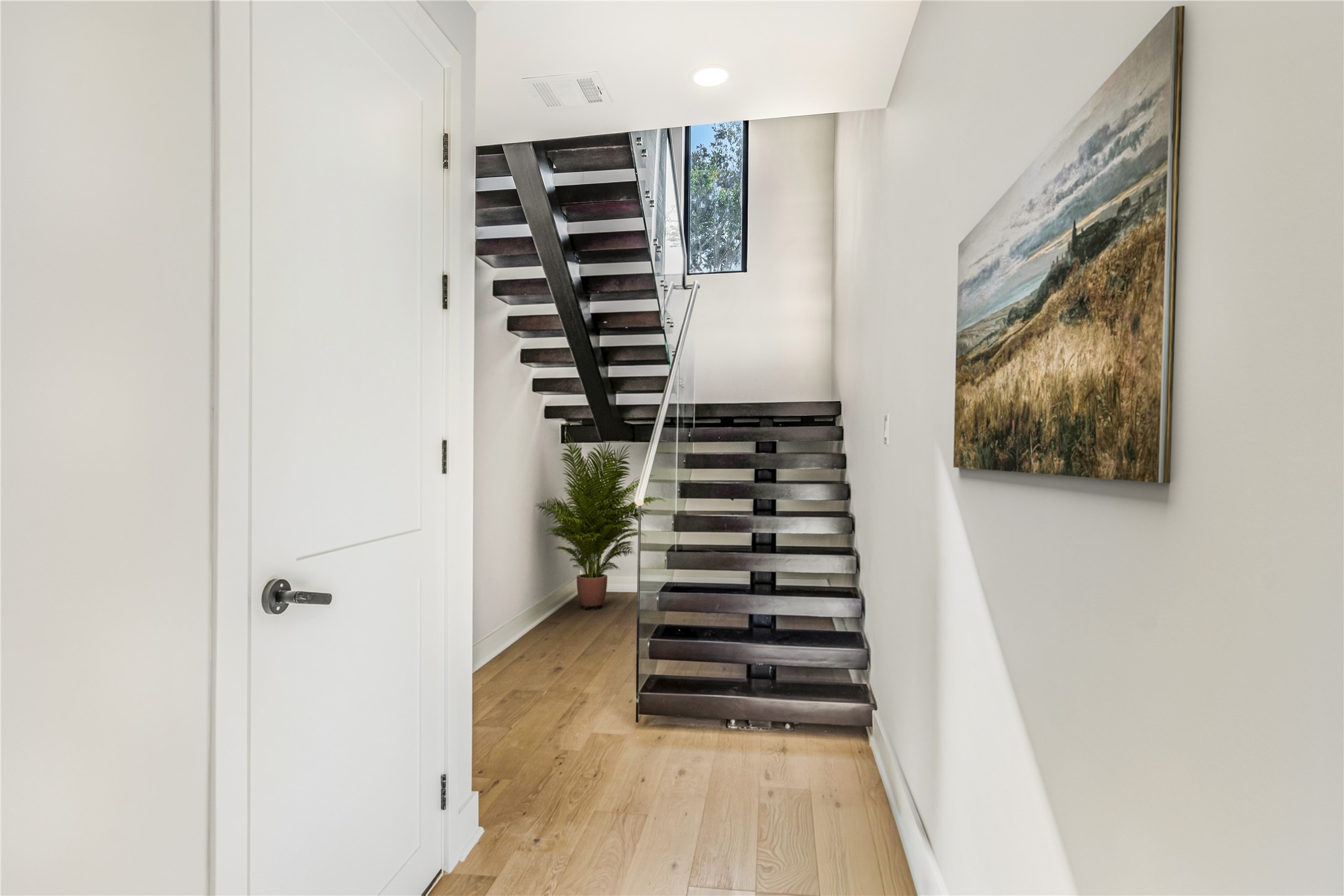 2235 Blalock Road Houston, TX 77080 - Photo 3 of 33 a view of a staircase with wooden floor and windows