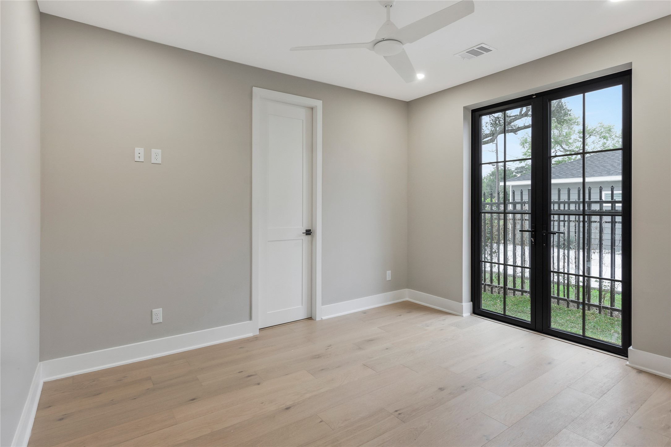 2235 Blalock Road Houston, TX 77080 - Photo 4 of 33 a view of an empty room with wooden floor and a window