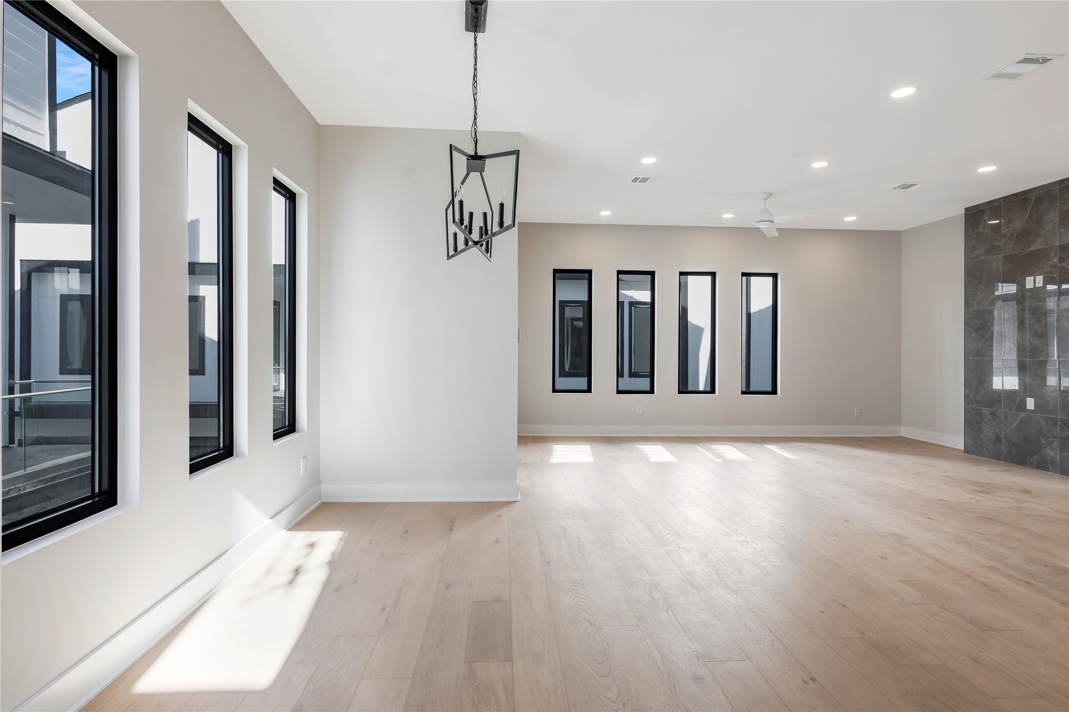 2235 Blalock Road Houston, TX 77080 - Photo 7 of 33 a view of an empty room with wooden floor and a window