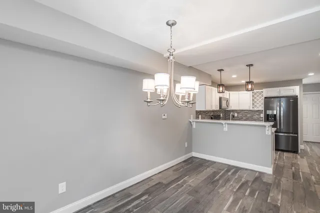 a view of a kitchen with wooden floor