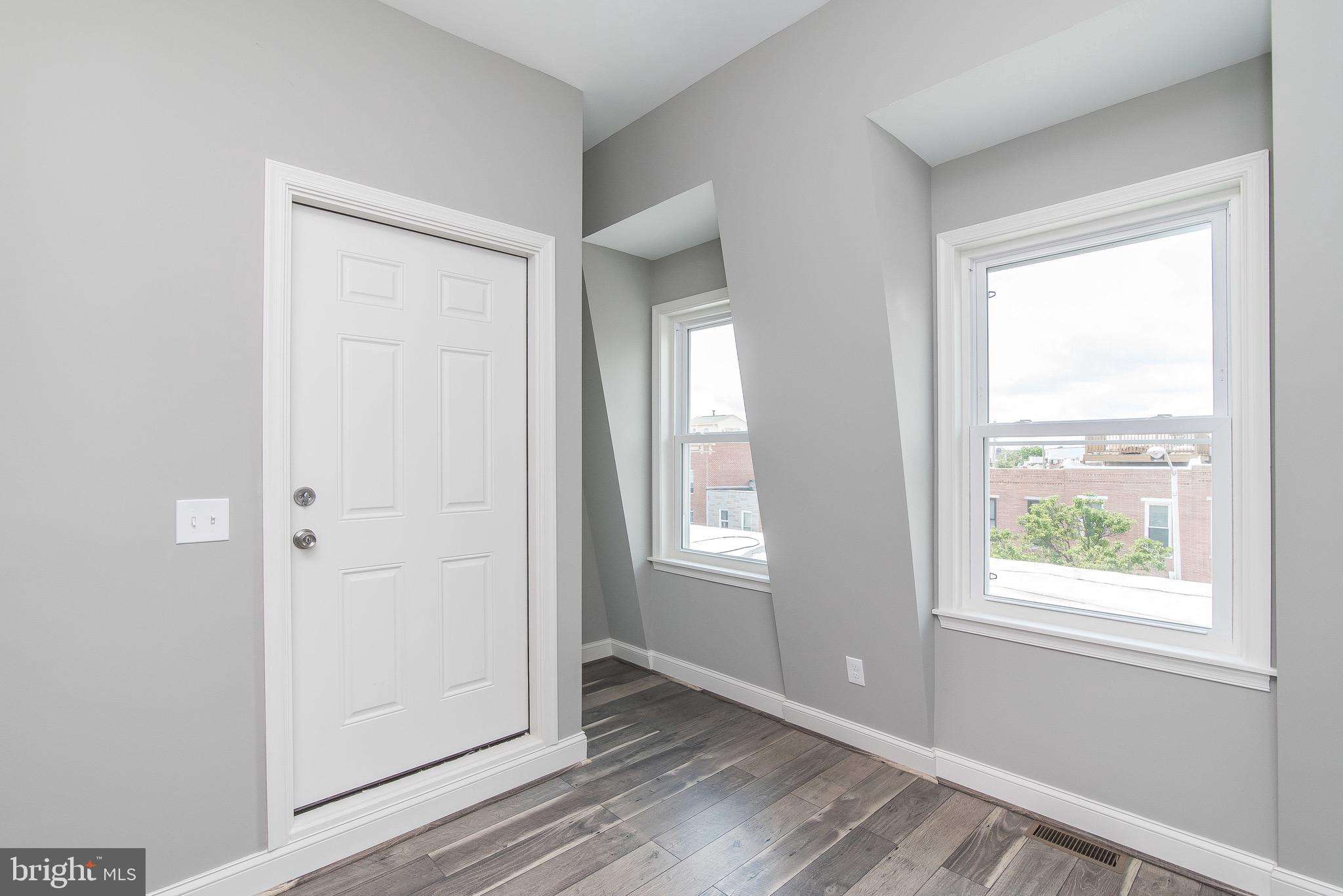 704 East Fort Avenue Baltimore, MD 21230 - Photo 14 of 58 a view of an empty room with wooden floor and a window