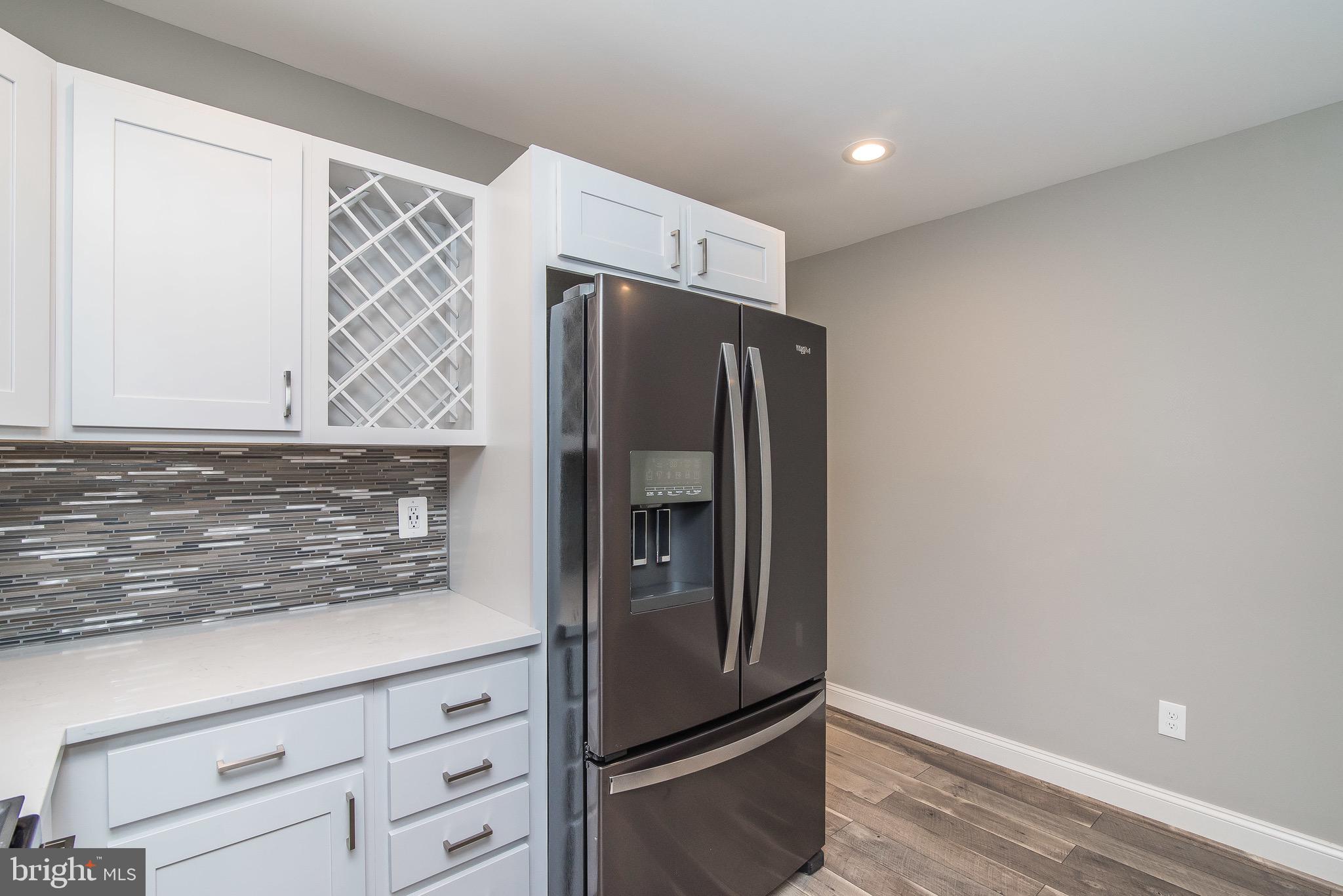 704 East Fort Avenue Baltimore, MD 21230 - Photo 15 of 58 a kitchen with stainless steel appliances granite countertop a refrigerator and a sink