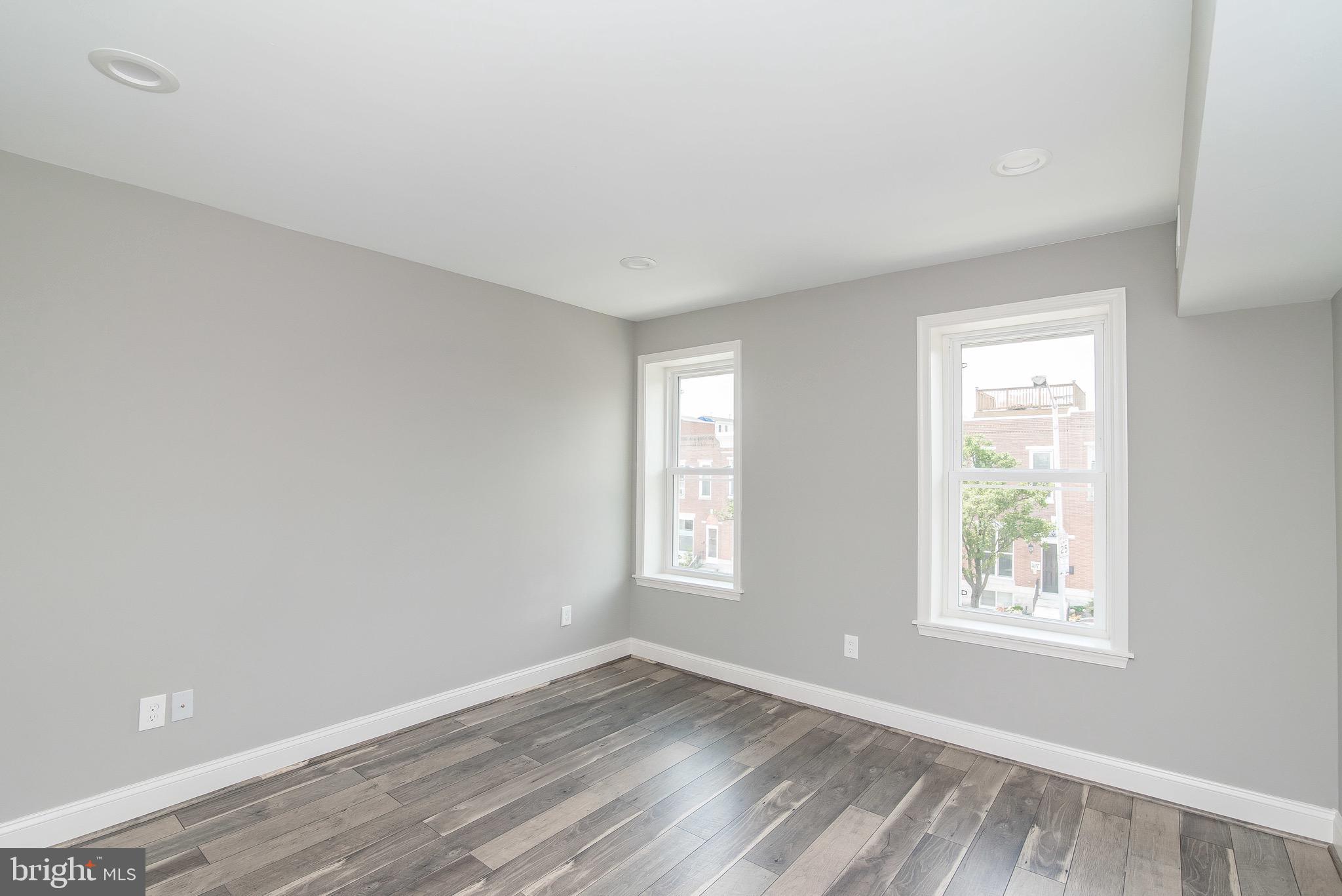 704 East Fort Avenue Baltimore, MD 21230 - Photo 17 of 58 a view of an empty room with wooden floor and window