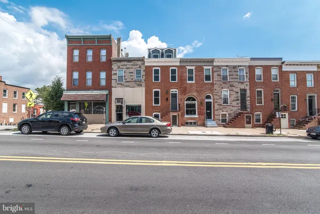 a view of a street that has couple of cars parked on the road