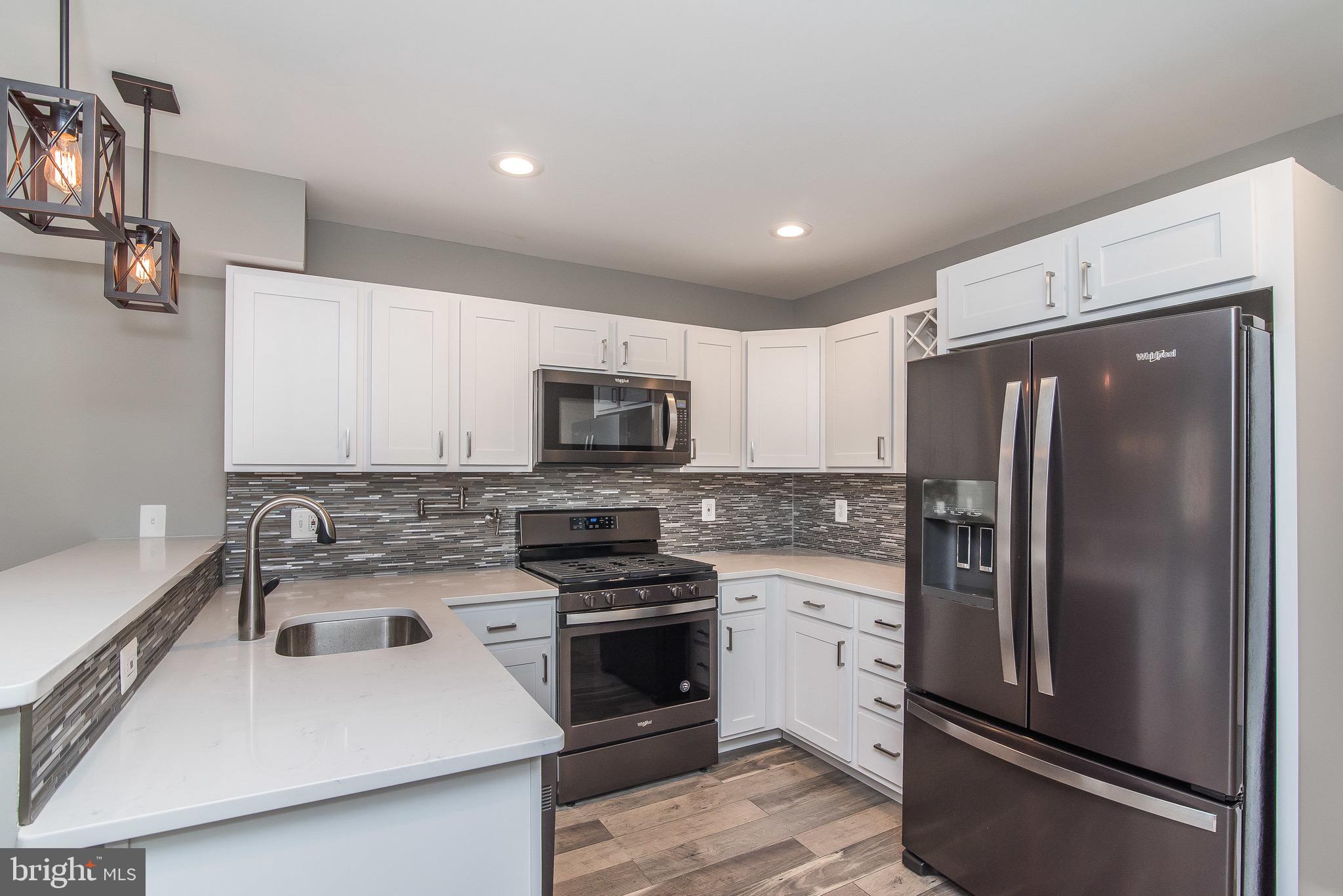 704 East Fort Avenue Baltimore, MD 21230 - Photo 2 of 58 a kitchen with stainless steel appliances a refrigerator sink and microwave