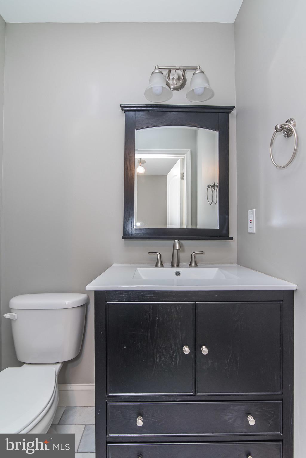 704 East Fort Avenue Baltimore, MD 21230 - Photo 22 of 58 a bathroom with a toilet sink and mirror