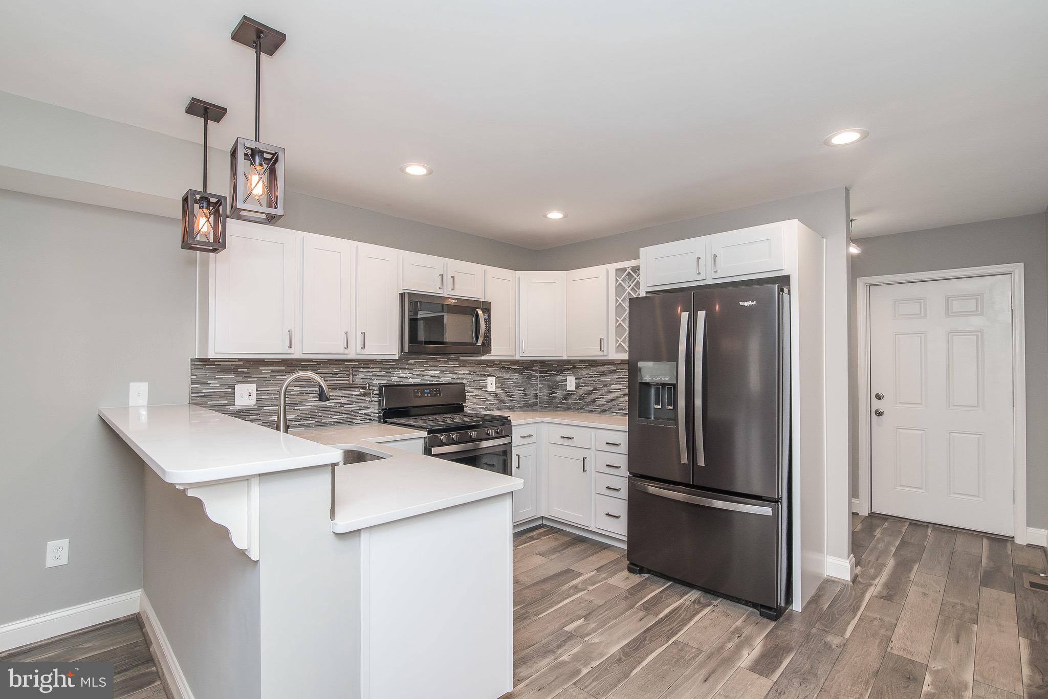 704 East Fort Avenue Baltimore, MD 21230 - Photo 23 of 58 a kitchen with stainless steel appliances a refrigerator stove and microwave