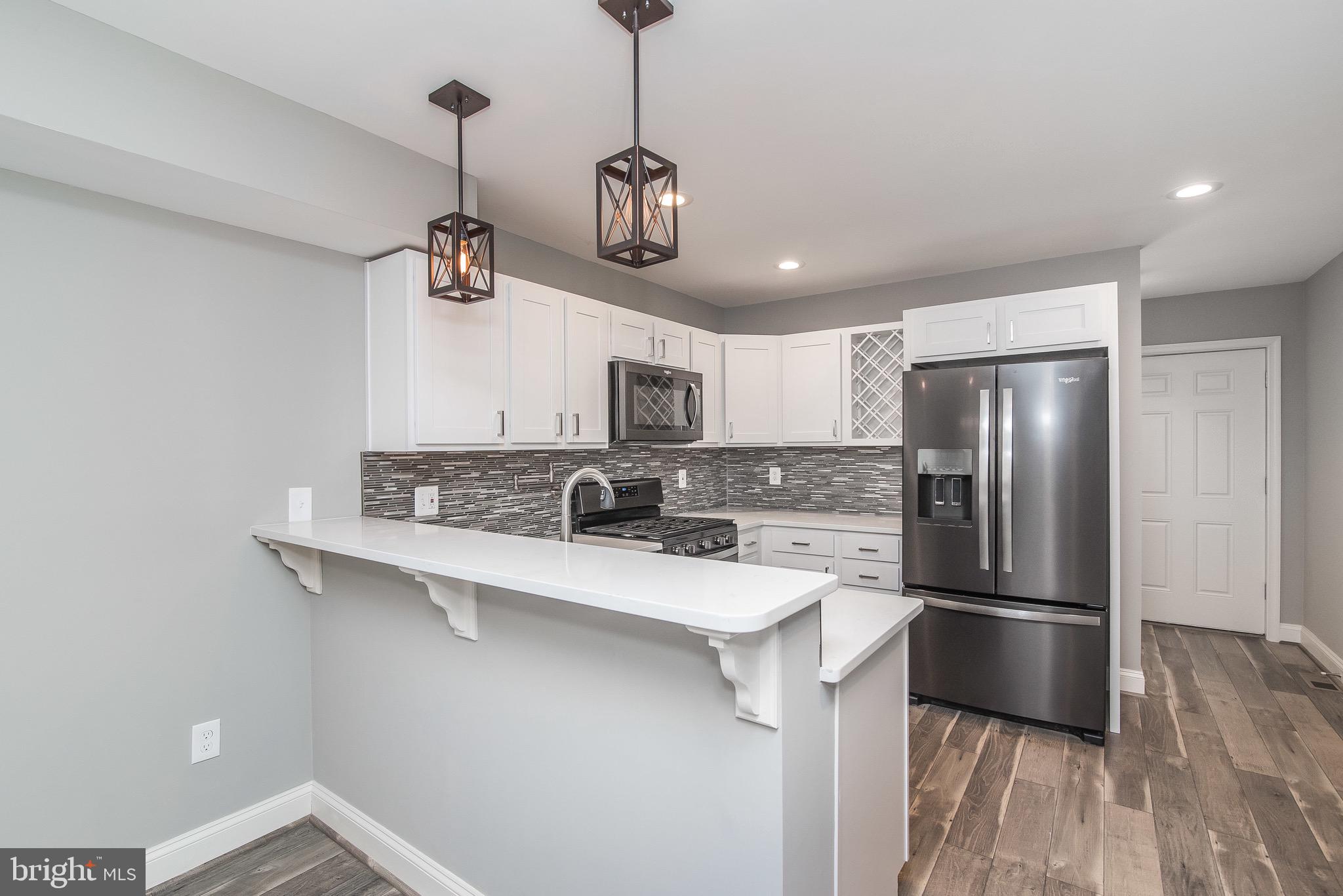 704 East Fort Avenue Baltimore, MD 21230 - Photo 25 of 58 a kitchen with stainless steel appliances granite countertop a sink a stove and refrigerator